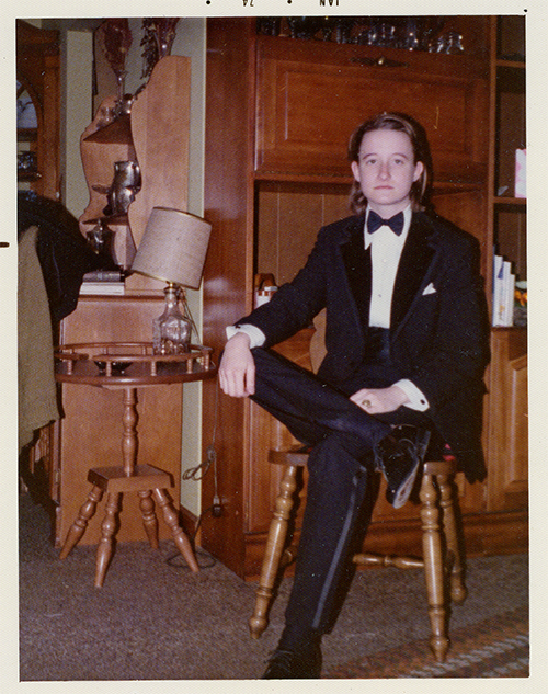 Courtesy of Gay, Lesbian, Bisexual, Transgender Historical Society Lou Sullivan sits dramatically, and somewhat seriously, in a tuxedo with his hair slicked back behind his ears, stylishly. Lou Sullivan pictured in 1974 before attending the GPU’s drag ball.